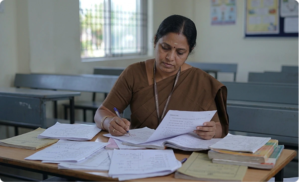 Teachers preparing examinations manually before implementing Maazter Customized Question Papers